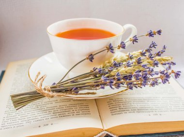 Lavender and a cup of tea on a book