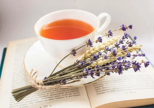 Lavender and a cup of tea on a book — Stock Photo, Image