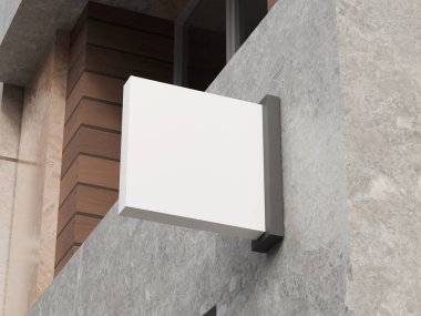 Gri taş alışveriş merkezi duvarının dış tarafında modern kare logosu var.