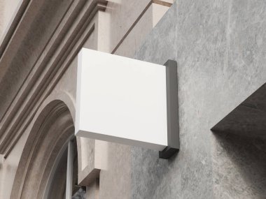 Modern dükkan duvarı mermer cephede kare şeklinde tabelayı monte etmiş.