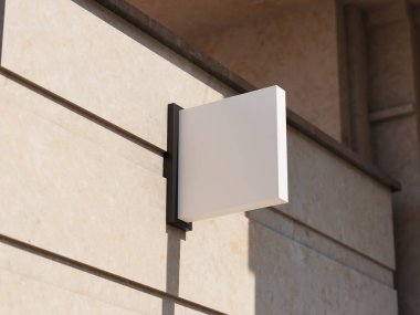 Bej desenli duvarda gölgeli modern asılı beyaz tabela.