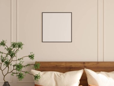 Yatak odasının duvarında iki kare fotoğraf çerçevesi, rahat dekor ve vazoda yeşil bitki var..