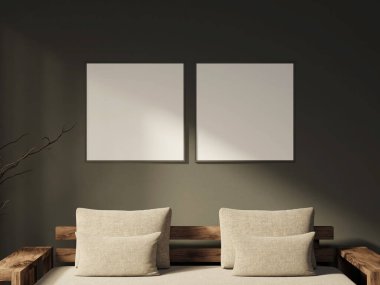 İki kare siyah çerçeve, karanlık bir duvarda yan yana asılı duruyor.