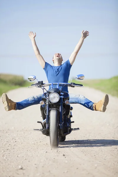 Young man on a motorcycle on a sunny day