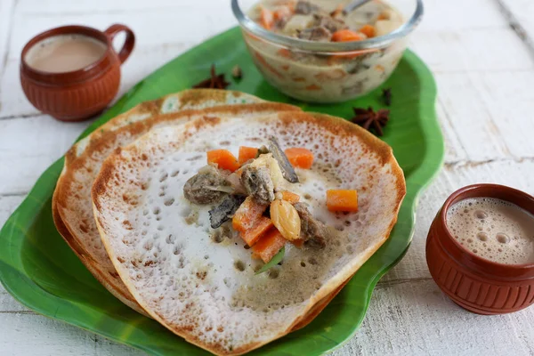 Appam with mutton stew Non-vegetarian sadhya Indian food for Onam sadya Christmas Easter celebration Kerala India Sri Lanka hoppers beef fry fish curry rice on banana leaf