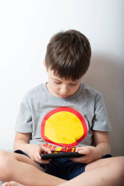 Portrait of young boy using a smartphone online gaming