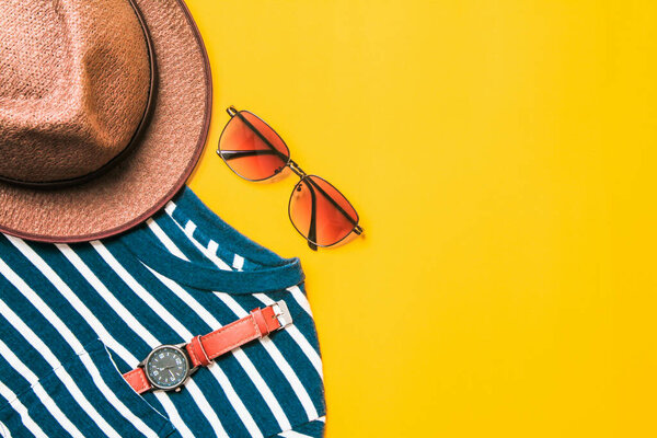 casual woman  and man of clothes and accessory glasses,watch,retro hat, on yellow paper background. Top view copy space for text.