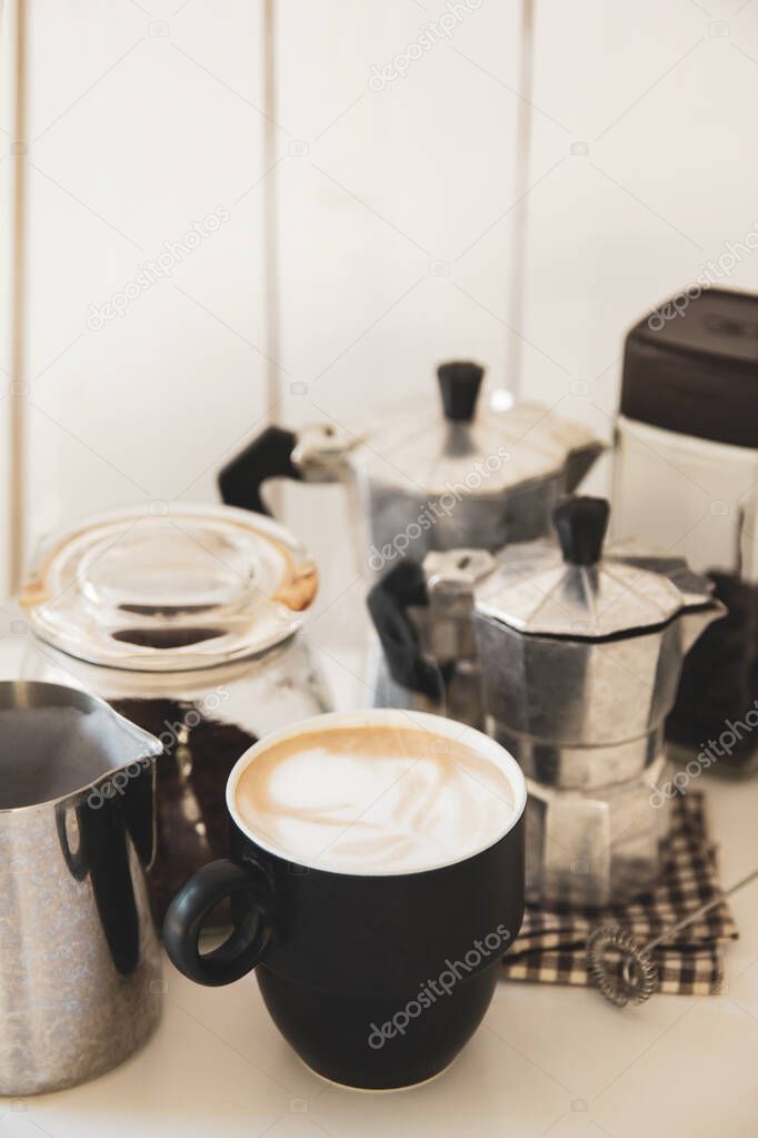 coffee of cup with equipment make coffee,mokapot, bean on white table of wood 