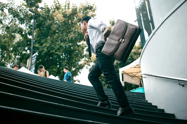階段を走っている茶色の革のバッグを持っている若いアジアのビジネスマンは オフィス急いで仕事時間行く — ストック写真