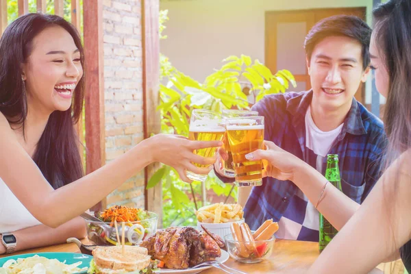 Two asian woman and one men.Drinking beer,are smile.Group celebration party eating happy, concept