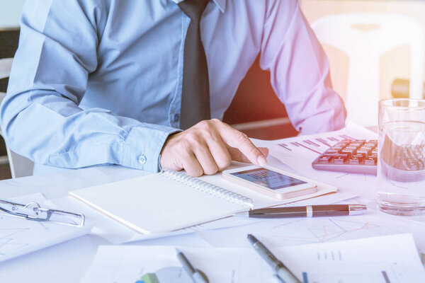 Asian young businessman holding mobile phone chat Meetings the commercial processes involved in promoting and selling and distributing a product or service