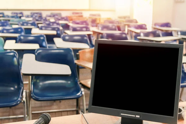 computer with blank copy space for your text message .In classroom with out ,No student or teacher .. Selective Focus with sunset light.