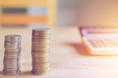 Günbatımına odaklı mali hesaplar ve madeni paralar masada.