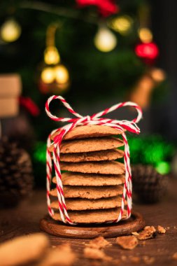 Şenlikli iple sarılmış el yapımı kurabiyeler, Noel ve yeni yıl ruhunu yakalıyor samimi, dikey tatil fotoğrafı konseptiyle mükemmel bir hediye olarak..