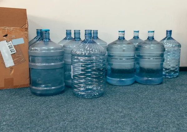 Plastic water bottles on the floor in the office.