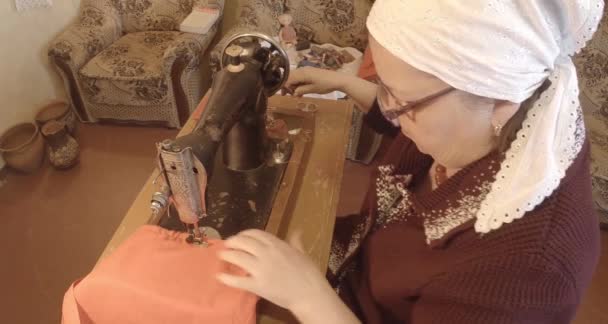 Großmutter näht eine rote Fahne auf einer alten Nähmaschine der Sowjetunion retro, siehe die gesamte Kollektion - viele Super-Großaufnahmen, Rohformat zur Farbkorrektur — Stockvideo