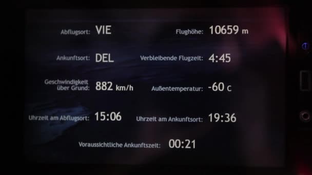 El avión despega en el aeropuerto. Exterior e interior. La gente y la azafata en el avión se van. La pantalla del televisor muestra los parámetros del vuelo . — Vídeos de Stock