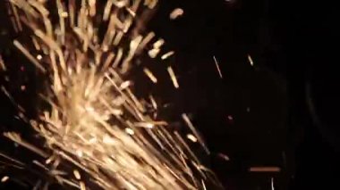 Sihirbaz bir metal davul sihirli sparks bir eski gaz çanta sonuçları yüzey parlatma üretimi için gaz çanta metal yüzey temizler çalışan karanlık bir garajda açı değirmeni grev kıvılcım