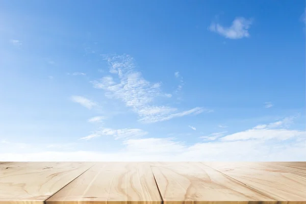 empty wooden table with sky and white cloud