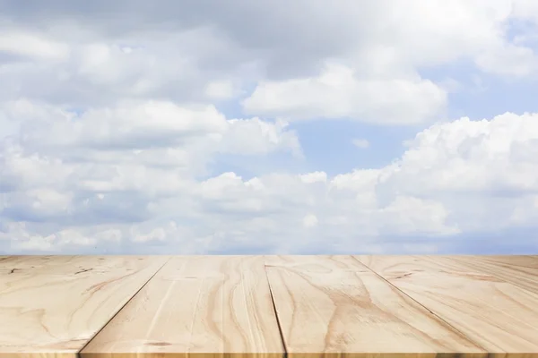empty wooden on blue sky nature backdrop. Wood table top. can used for display or montage your products