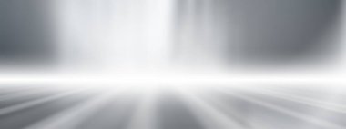 Uzun, yumuşak, gri stüdyo arka planı, geniş gri zemin arkaplanı spot ışıklarıyla.