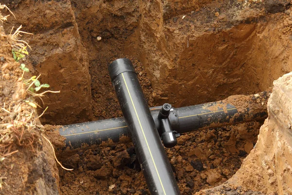 Extension of underground PVC water pipeline in clay pit