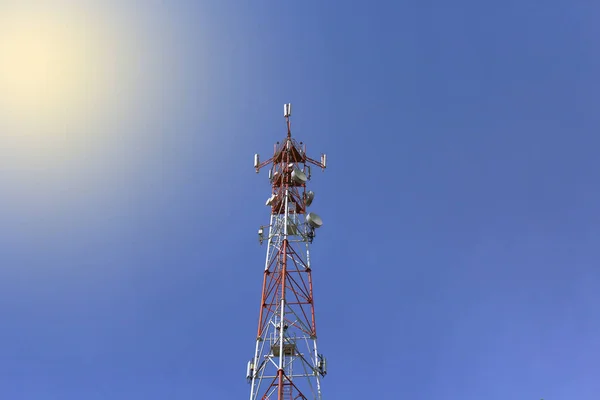 Telecommunication towers with wireless antennas on sky background  with solar illumination. Cellular phone antenna. Technology on the top of the telecommunication GSM 5G,4G,3G tower.