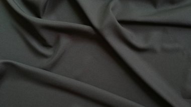 arkaplan için dalga desenli soyut siyah kumaş.