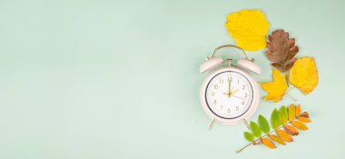 Autumn time change, end of daylight saving time, alarm clock fall back switch, colorful foliage, winter seaso