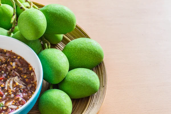 Cup sauce and mango on wooden — Stock Photo, Image