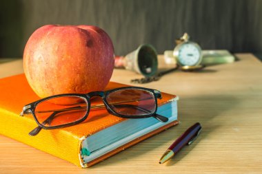 glasses and stationery on wooden