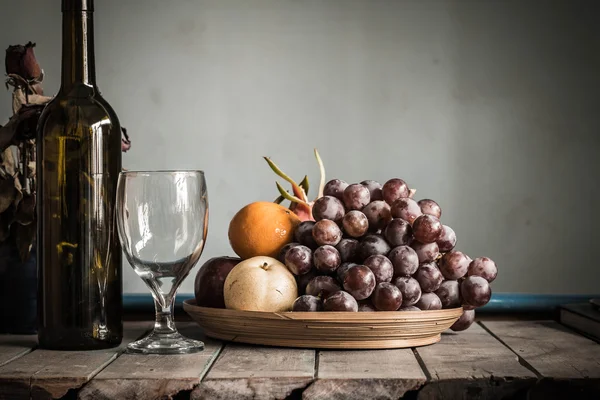 Fruit tray and a bottle — Stock Photo, Image
