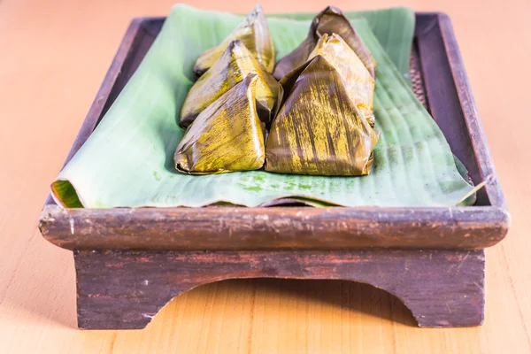 Dessert wrapped in banana leaves — Stock Photo, Image