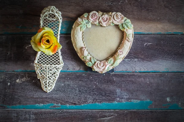 Picture frames and flowers on wooden — Stock Photo, Image