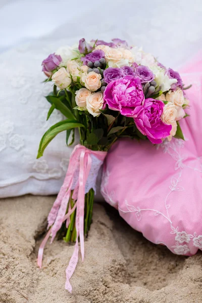 Beautiful, delicate bridal bouquet among decorations with pillow — Stock Photo, Image