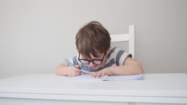 4k. little cute caucasian boy in glasses study, write — Stok video