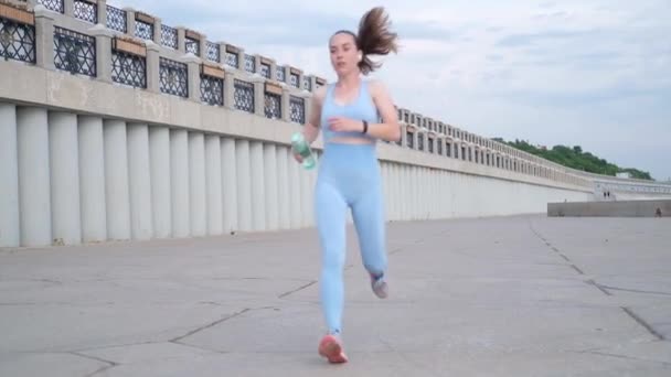 Молодая счастливая фитнес женщина закончить бег, проверить умные часы в городе — стоковое видео