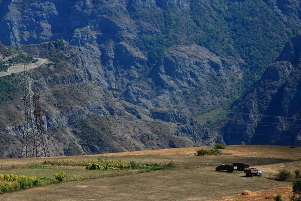 Three trucks on the background of Caucasus mountains — Stock Photo, Image