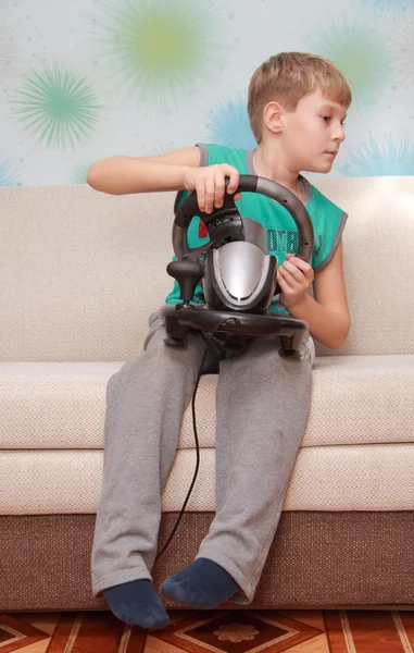 Child on couch with computer-game device — Stock Photo, Image