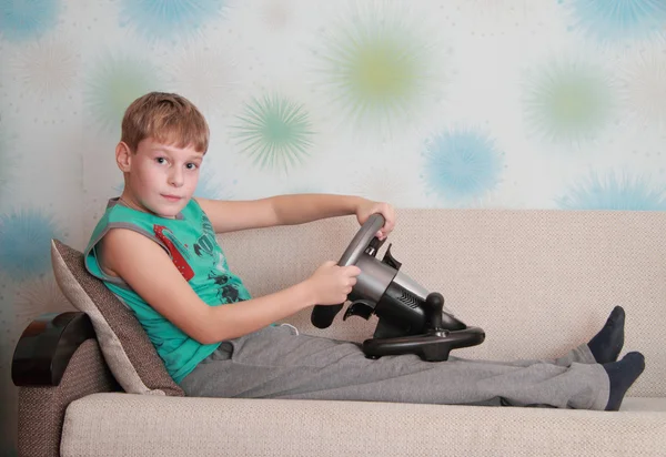 Child on couch with computer-game device — Stock Photo, Image