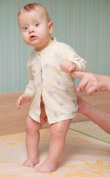 Baby standing on a cot — Stock Photo, Image