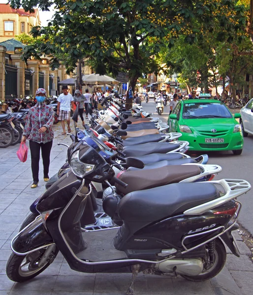 Les gens marchent presque la rangée de scooters à Hanoi — Photo