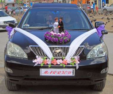 car with bride and her mom stopped on the street in Ulaanbaatar, Mongolia