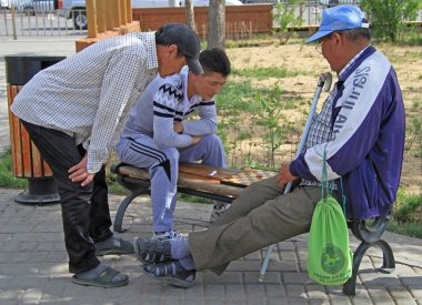 two men are playing checkers in park of Ulaanbatar, Mongolia