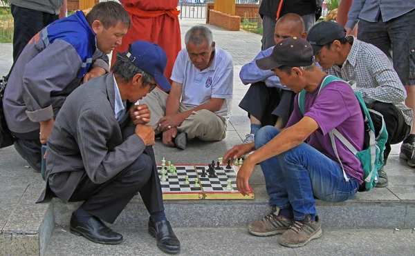 group of people is watching chess game on the street in Ulaanbaatar