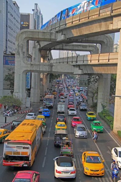 people in cars, buses and on motorbikes are moving outdoor, Bangkok, Thailand