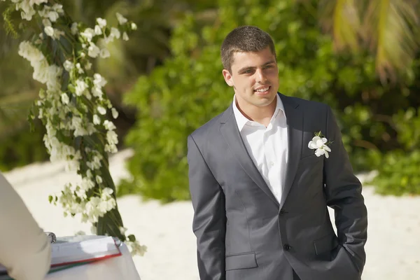 Novio guapo esperando novia durante la ceremonia en la playa . — Foto de Stock