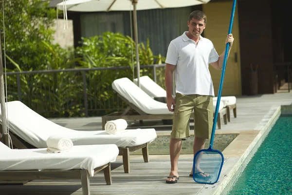 Swimming pool cleaner, professional cleaning service at work.