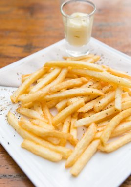 French fries served on a white plate