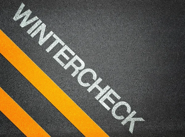 Wintercheck tekst schrijven weg asfalt — Stockfoto